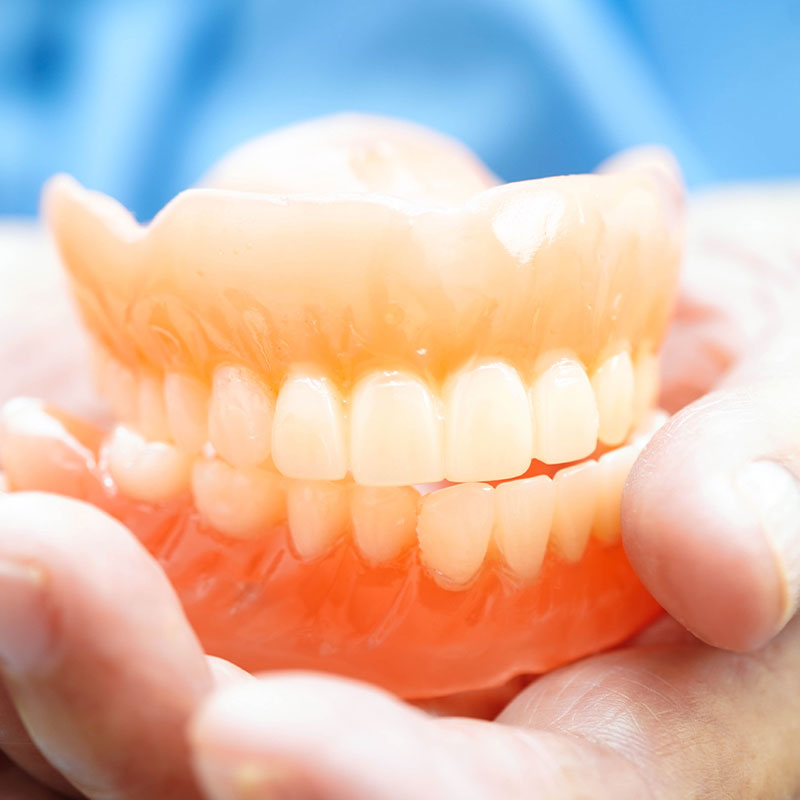 denture being held