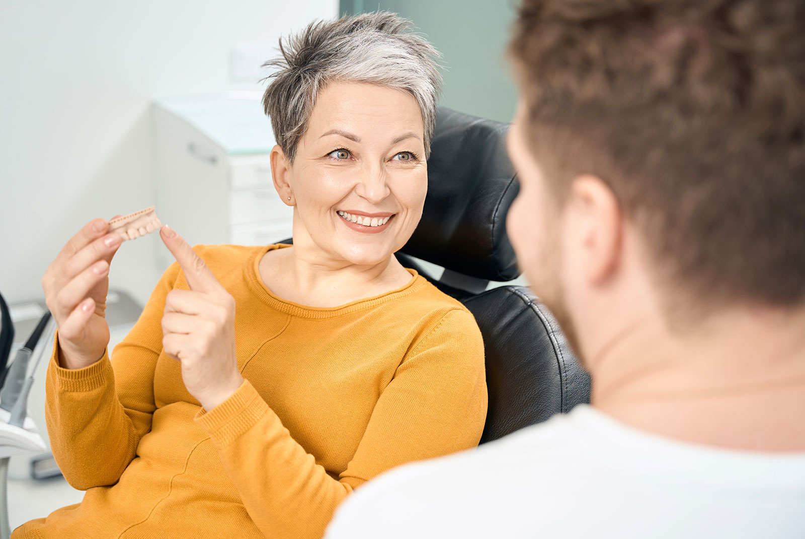 lady learning more about dental bridge