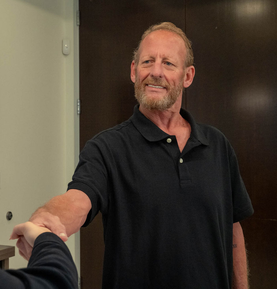 man being welcomed